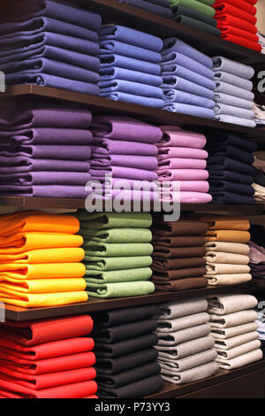 Colorful Pullovers Variety Folded in Shelf Stock Photo