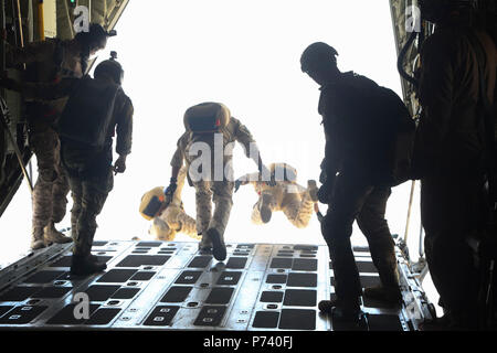 Bahraini Special Forces jump out of a U.S. Marine Corps KC130-J attached to Marine Aerial Refueler Transport Squadron (VMGR) 352, Special Purpose Marine Air-Ground Task Force-Crisis Response-Central Command, during free fall parachute training over Bahrain, May 11, 2017. Deploying U.S. Marines into the USCENTCOM area of operation to conduct combined military training with our partner nations’ security forces strengthens our vital relationships with partners in this important region. Stock Photo