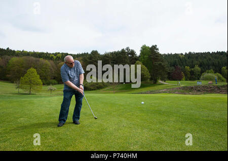 Retired Chief Master Sgt. Charles E. Milam takes a swing during a round of golf at the Golf-Club Pfälzerwald e.V. in Waldfischbach-Burgalben, Germany, May 11, 2017. Milam was awarded the U.S. Air Force Meritorious Service for training over 1,000 security police in 1968 while deployed on his first tour in Vietnam. Stock Photo