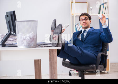 Young handsome businessman employee working in office in paperwork concept Stock Photo