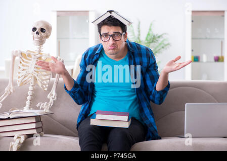 Student studying with skeleton preparing for exams Stock Photo