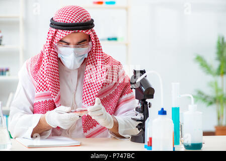 Arab doctor chemist studying new virus in lab Stock Photo