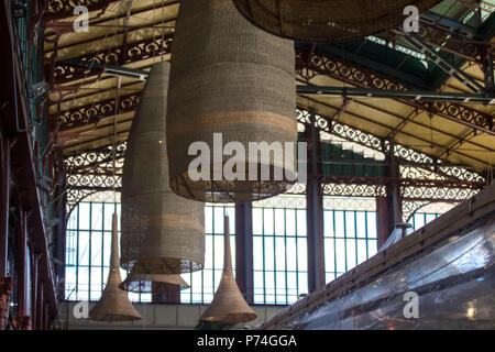 FLORENCE, ITALY - NOVEMBER 22 2015: Interiors of San Lorenzo market in Florence, straw lamps and industrial architecture Stock Photo