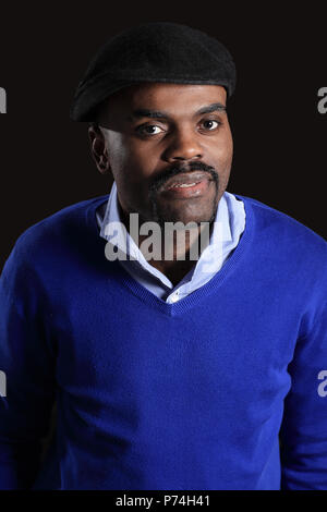 Black business man overturned hat, black background Stock Photo