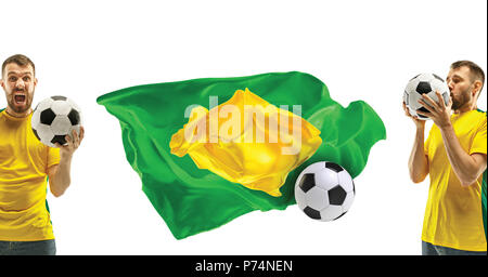 Brazilian fan celebrating on white background. The young man in soccer football uniform with ball standing at white studio. Fan, support concept. Human emotions concept. Stock Photo