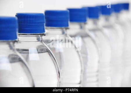 row of water bottle lids with select focus on second bottle Stock Photo