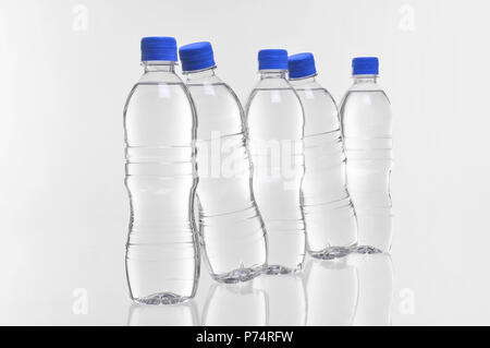 five plastic water bottles with two at an angle Stock Photo