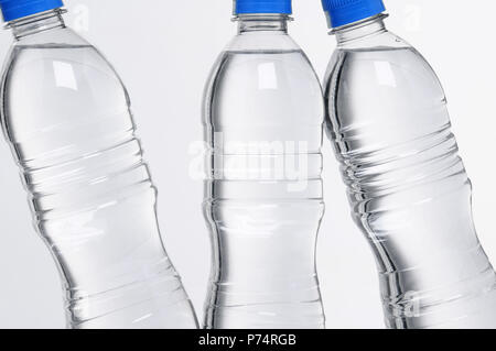 closeup of three plastic water bottles with blue lids Stock Photo