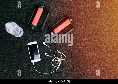Set of water, phone, gloves, headphones on black background Stock Photo