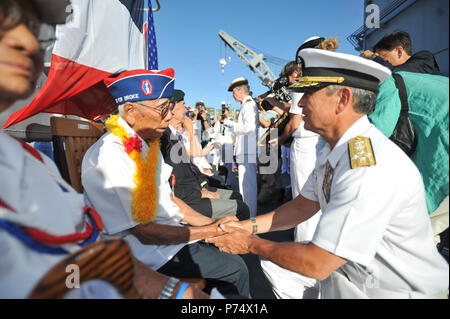 PEARL HARBOR (July 2, 2014) Adm. Harry Harris Jr., commander of U.S. Pacific Fleet, thanks Ralph Tomei, a 442nd RCT veteran, for his contributions during World War II.  Tomei represented his friend Shiro Aoki as Rear Adm. Anne Cullere, commander in chief of French forces in the Pacific, presented him with the French Nation Order of the Legion of Honor aboard the French Floréal-class frigate FS Prairial (F731). For more than a decade the government of France has presented the Legion of Honor to U.S. veterans who participated in the liberation of France during World War II. The ceremony took pla Stock Photo