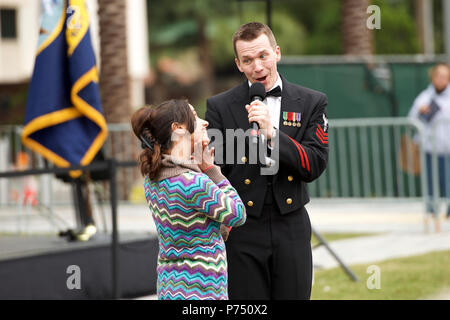 ORLANDO, Fla. (March 7, 2015) Musician 1st Class William Edwards, of Bowie, Md., sings to an audience member during a U.S. Navy Band concert at the Dr. Phillips Center for the Performing Arts in Orlando, Fla. The U.S. Navy Band is touring the Southeast United States, with performances in 32 cities. Stock Photo