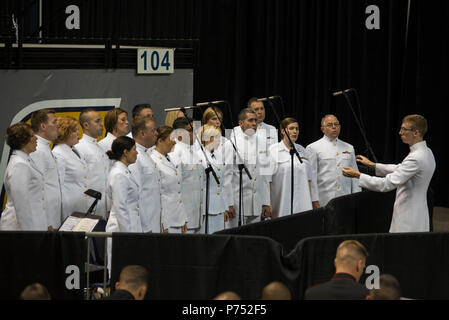 CHATTANOOGA, Tenn. (August 15, 2015) Musician 1st Class Adam Whitman, left, conducts the U.S. Navy Band Sea Chanters chorus at the begining of the Navy and Marine Corps Chattanooga, TN Memorial in Chattanooga, Tenn. The Navy and Marine Corps family and the City of Chattanooga honored the four Marines and one Sailor who were killed in an attack on July 16 at the Navy Operational Support Center (NOSC) and Marine Corps Reserve Center. The memorial service took place on Saturday at the McKenzie Arena, University of Tennessee Chattanooga. Stock Photo