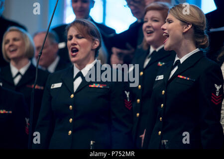 ANNANDALE, VIRGINIA  (October 30, 2016) Petty Officers 1st Class Maia Rodriguez, left and Chelsi Ervein, as they perform with the U.S. Navy Band Sea Chanters chorus during the chourus' 60th anniversary concert. The Sea Chanters chorus celebrated their 60th anniversary iin Annandale, Virginia, with a concert featuring alumni from the group. The chorus was formed as an all-male group in 1956 and tasked with perpetuating the songs of the sea. In 1980, the group added women to their ranks and expanded their repertoire to include everything from Brahms to Broadway. Stock Photo