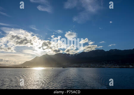 Leaving Ushuaia on an expedition cruise ship with passing clouds over the mountain range, Argentina Stock Photo