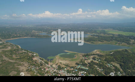 Aerial view of Paoay lake against background of mountains and sky with clouds. Paoay Lake National Park, Ilocos Norte, Philippines. Stock Photo