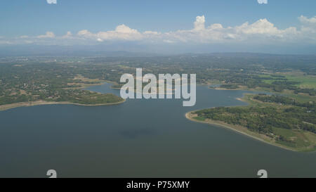 Aerial view of Paoay lake against background of mountains and sky with clouds. Paoay Lake National Park, Ilocos Norte, Philippines. Stock Photo