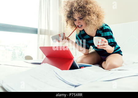 Telecommuting woman being desperate having no clue Stock Photo
