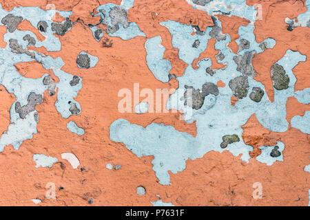 Old painted wall with cracks. Lot of previous paint layers revealed. Retro aged background Stock Photo