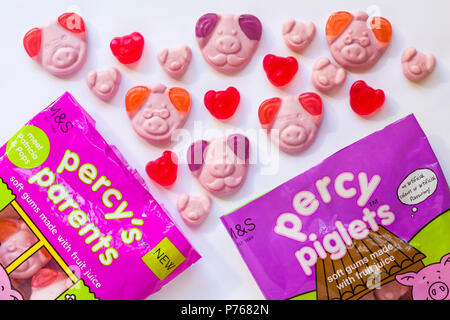 Packets of percy's parents and percy piglets percy pig sweets opened with contents spilled set on white background - soft gums made with fruit juice Stock Photo