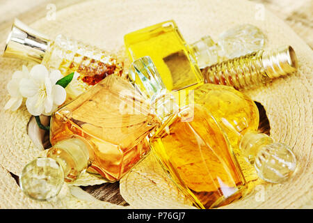Several vintage bottles of perfume on the woven straw Stock Photo