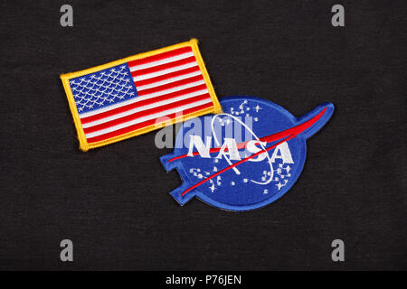 15 March 2018 - The National Aeronautics and Space Administration (NASA) emblem patch and US Flag patch on black uniform background Stock Photo