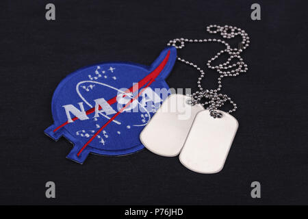 15 March 2018 - The National Aeronautics and Space Administration (NASA) emblem patch and dog tags on black uniform background Stock Photo