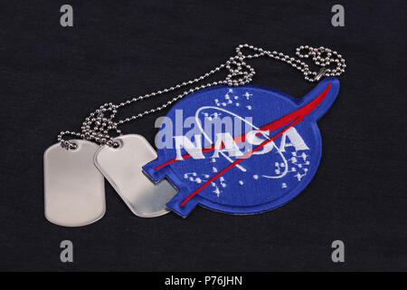 15 March 2018 - The National Aeronautics and Space Administration (NASA) emblem patch and dog tags on black uniform background Stock Photo