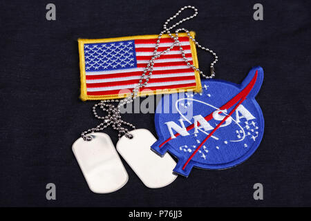 15 March 2018 - The National Aeronautics and Space Administration (NASA) emblem patch, dog tags, and US Flag patch on black uniform background Stock Photo