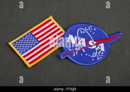 15 March 2018 - The National Aeronautics and Space Administration (NASA) emblem patch and US Flag patch on green uniform background Stock Photo