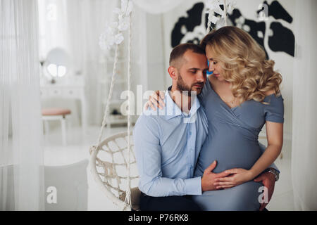 Beautiiful couple of pregnant woman and her husband embracing. Stock Photo