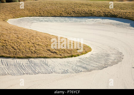 Close up of raked sand patterns in golf bunker - machine raked sand traps. Stock Photo