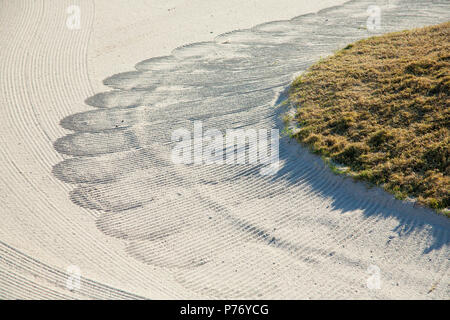 Close up of raked sand patterns in golf bunker - machine raked sand traps. Stock Photo