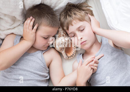 Brothers - a lazy morning in bed, bedding. Fun and rest, relax, lazy Sunday