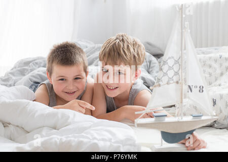 Brothers - a lazy morning in bed, bedding. Fun and rest, relax, lazy Sunday