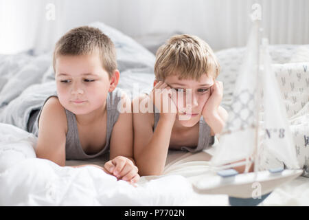 Brothers - a lazy morning in bed, bedding. Fun and rest, relax, lazy Sunday