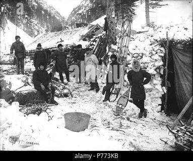 Klondikers With Snowshoes And Sleds Standing Outside Of Log Cabin