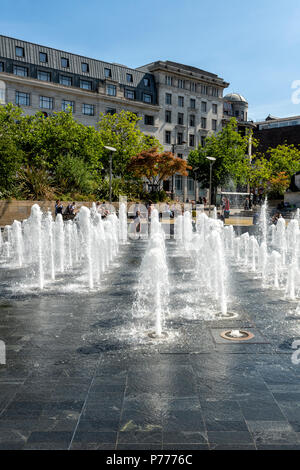 Dozens of water fountains provide entertainment and fun in Piccadilly Gardens, Manchester, UK Stock Photo