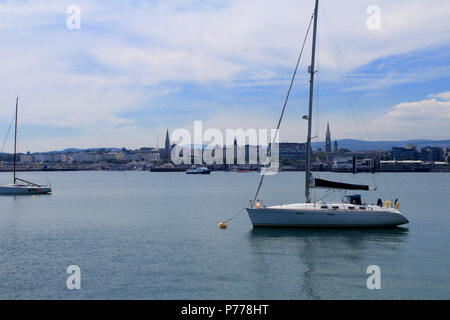 Dun Laoghaire Harbour with the church spires of the town centre in the background. Stock Photo