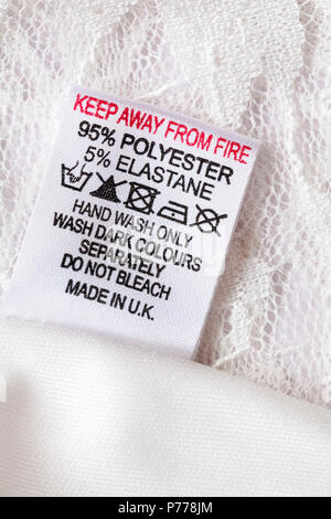 keep away from fire label in clothing made in UK - 95% polyester 5% elastane hand wash only wash dark colours separately do not bleach Stock Photo