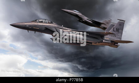 US Air Force McDonnell Douglas, two F-15E Strike Eagle aircraft low flying close up through storm clouds. Located near Lakenheath Suffolk in England U Stock Photo
