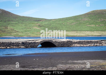 Low water levels in Northern Ireland Reservoir reveal old bridge Stock Photo