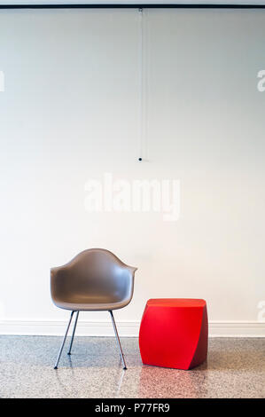 Empty conference room with only a chair and red abstract side table Stock Photo