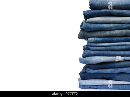 Stack different blue pants, with jeans texture isolated on white background. Stock Photo