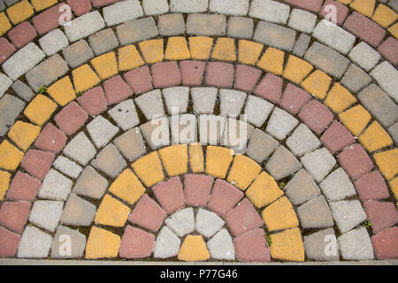 Colored tiles, masonry laid out in a semicircle. Patterned background Stock Photo