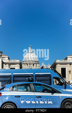 Police cars patrol in Via della Conciliazione by Saint Peter’s Basilica. Vatican City State. Rome, Italy, Europe Copy space, clear blue sky, close up. Stock Photo
