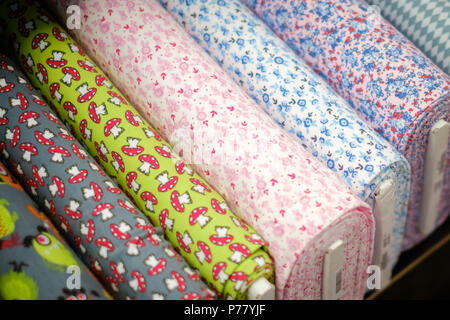 textile fabric rolls with  pattern on market  - Stock Photo