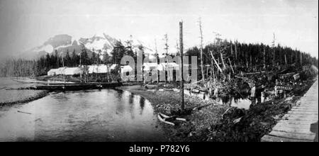 . English: Railroad construction camp probably in the vicinity of Alaganik, 1908 . English: Construction photographs of the Copper River and Northwestern Railway along the Copper River from 1906-1911. PH Coll 375.51 Subjects (LCTGM): Work camps--Alaska; Tents--Alaska; Mountains--Alaska; Rivers--Alaska Subjects (LCSH): Copper River (Alaska)  . 1908 11 Railroad construction camp probably in the vicinity of Alaganik, 1908 (HEGG 769) Stock Photo