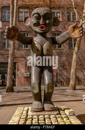 Native American wooden carved statue at  Occidental Park  in the heart of the historic Pioneer Square district ,Seattle ,WA Stock Photo