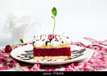 Cherry fruit cake with cream on a plate Stock Photo