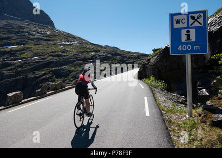 Female cyclist climbing the famous Trollstigen pass, Norway Stock Photo